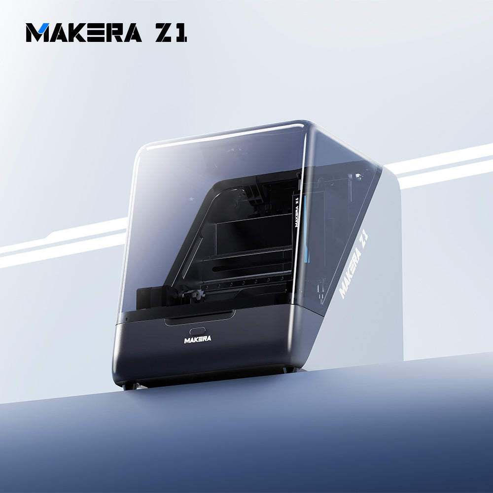 Makera Z1 compact desktop CNC machine for hobby projects, shown from a low angle with its transparent enclosure closed.