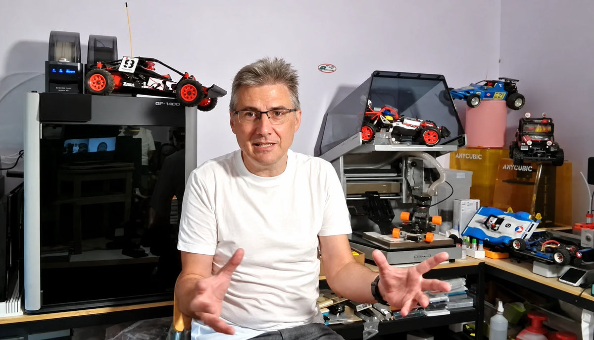 Marc of Silver Triple Designs in his workshop with RC cars, a 3D printer, and a Carvera Air CNC machine.